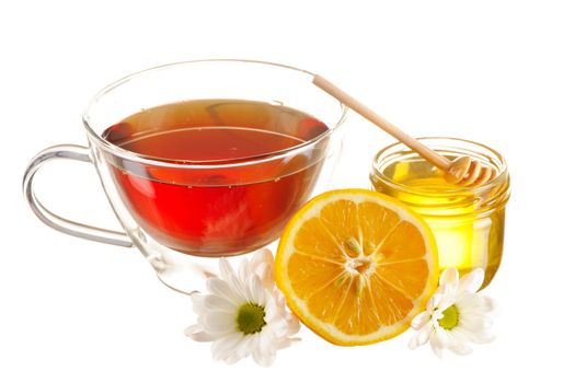Jar of honey and tea cup isolated over white