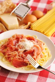 Pasta carbonara over red cloth