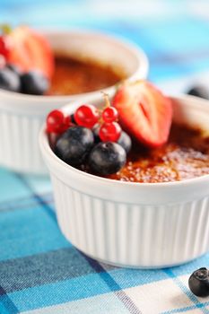 Creme brulee (cream brulee, burnt cream) with fruits and berries