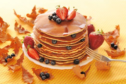Delicious freshly prepared pancakes with strawberry and blueberries