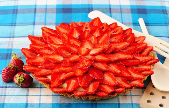 Homemade strawberry tart on table