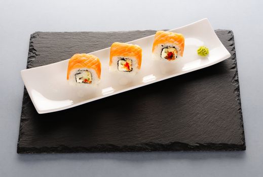 Sushi rolls on a slate plate
