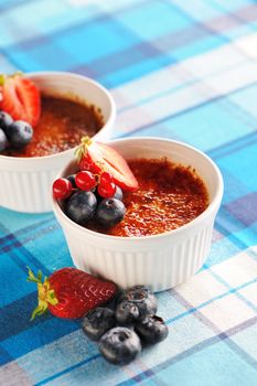 Creme brulee (cream brulee, burnt cream) with fruits and berries