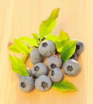 Blueberry with leafs on wooden table