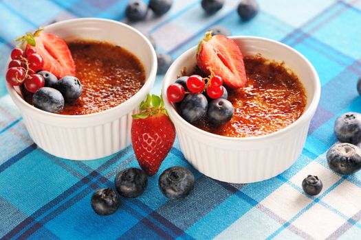 Creme brulee (cream brulee, burnt cream) with fruits and berries