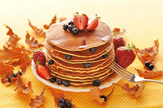 Delicious freshly prepared pancakes with strawberry and blueberries