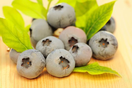 Blueberry with leafs on wooden table