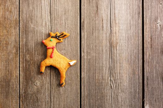 Christmas homemade gingerbread deer over wooden table