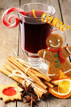 Glass of red mulled wine on wooden table