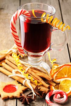 Glass of red mulled wine on wooden table