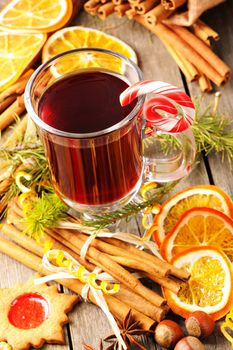 Glass of red mulled wine on wooden table