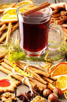 Glass of red mulled wine on wooden table