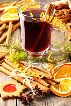 Glass of red mulled wine on wooden table