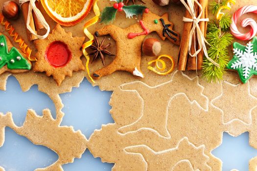 Christmas spices and cookies over homemade gingerbread dough