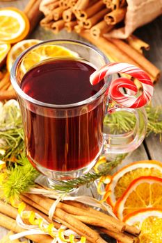 Glass of red mulled wine on wooden table