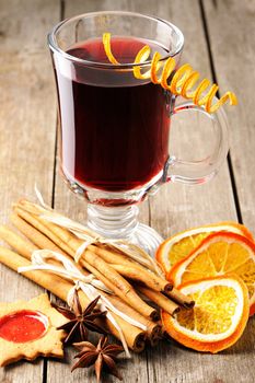 Glass of red mulled wine on wooden table