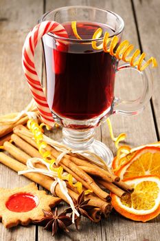 Glass of red mulled wine on wooden table