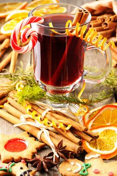 Glass of red mulled wine on wooden table