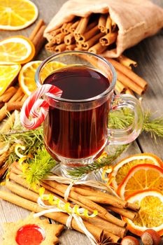 Glass of red mulled wine on wooden table