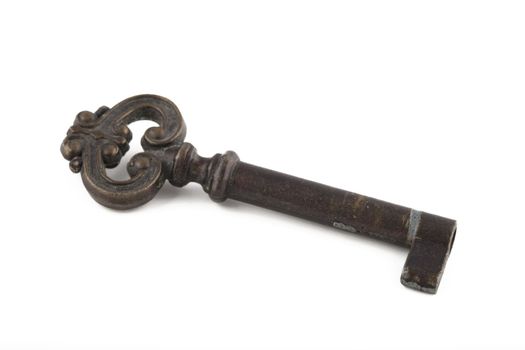 Antique skeleton key worn with age on white background, with shadow.