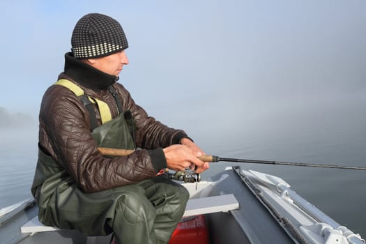 Fisherman in an inflatable boat fishing