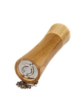 isolated bamboo pepper grinder with grains on white background