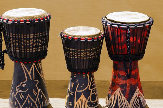 Three wooden and decorated African bongos, African art
