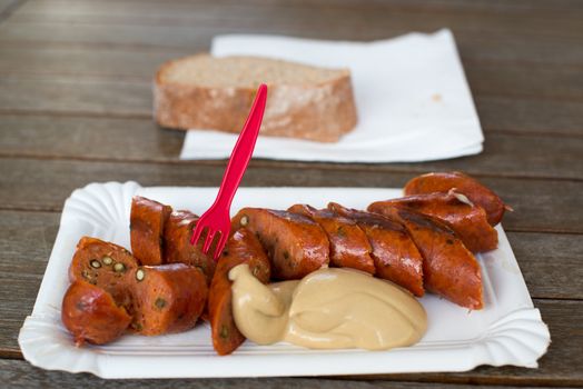 Famous Vienna sausage with mustard and bread served at the Naschmarkt, one of the oldest markets in Vienna, Austria