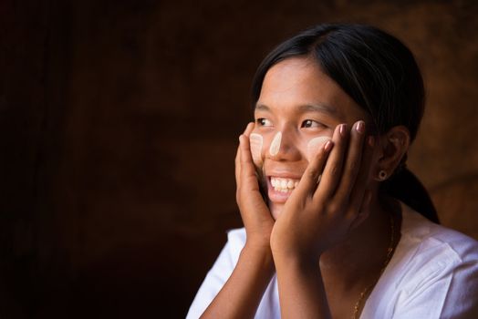 Myanmar girl hand holding on her face