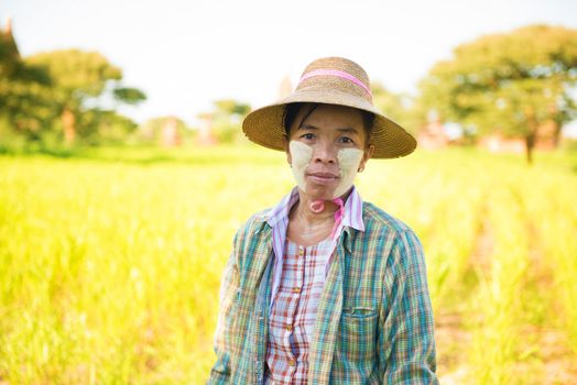 Portrait of a mature Burmese woman with thanaka powdered face who works in the field