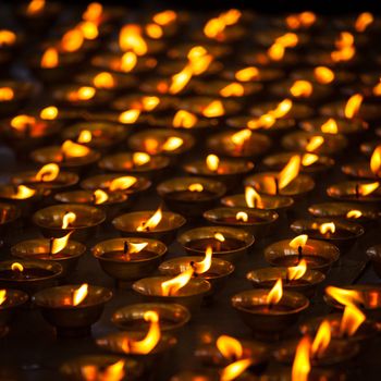 Burning candles in Buddhist temple. Tsuglagkhang complex,  McLeod Ganj, Himachal Pradesh, India