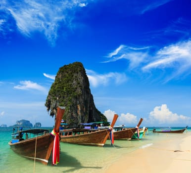 Long tail boat on tropical beach with limestone rock, Krabi, Thailand