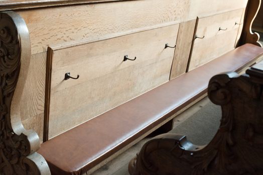 rows of beautifully decorated old wooden church benches