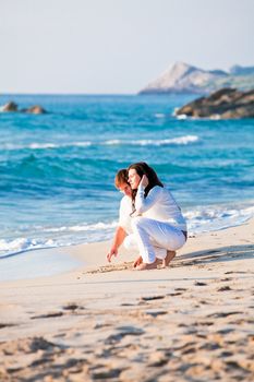 happy young family with daughter on beach in summer lifestyle