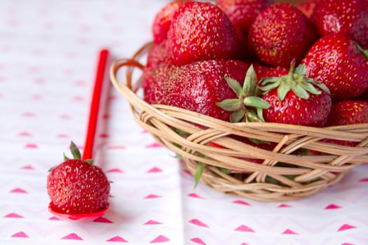 Fresh strawberries in a basket on a round table