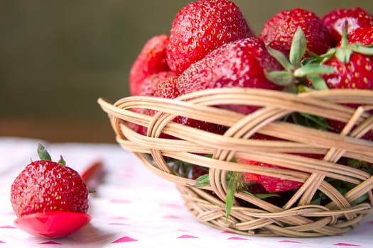 Fresh strawberries in a basket on a round table