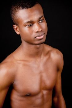 young african afro man with dark skin on black background