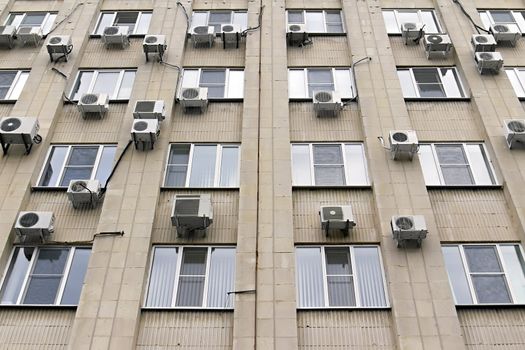 mani air conditioners on the  wall of office building