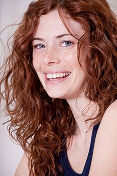 beautiful red head woman with freckled face and blue eyes