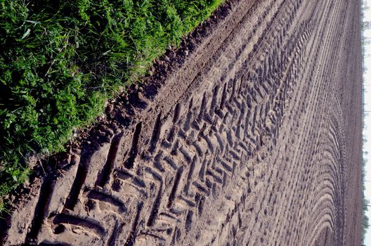 Leveled agricultural field and cargo machine marks on ground