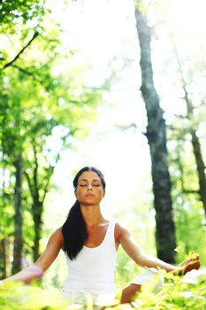 yoga woman on green grass in forest