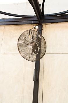 Wall-mounted fan applied to the exterior of the building.