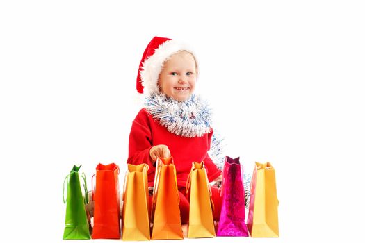 child  in red cap with Christmas presents