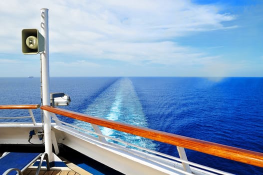 A cruise ship leaves a long wake in the Caribbean Sea near the Cayman Islands.