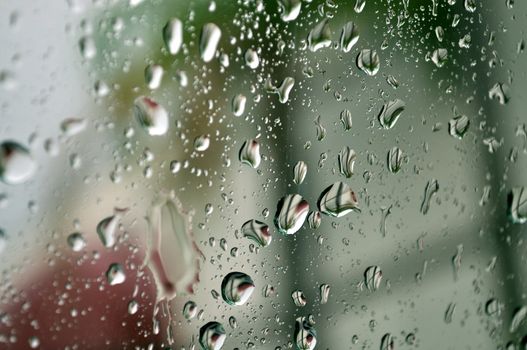 Raindrops cling to a car window after a brief shower.