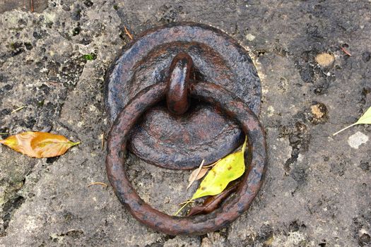 rusty old metal ring on a big stone wall