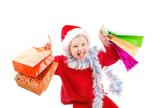 Child dressed as Santa with bags of presents