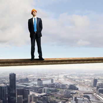 Businessman standing in suit on the construction site