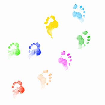 Colourful human foot prints on white background