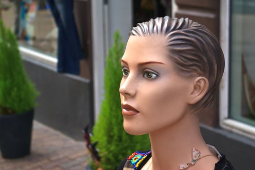 Fashion Mannequin woman face dummy in front of a shop store